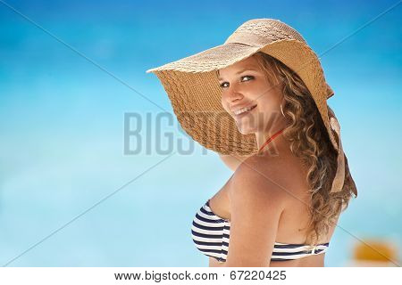 Portrait Of Woman With Straw Hat At Beach Smiling