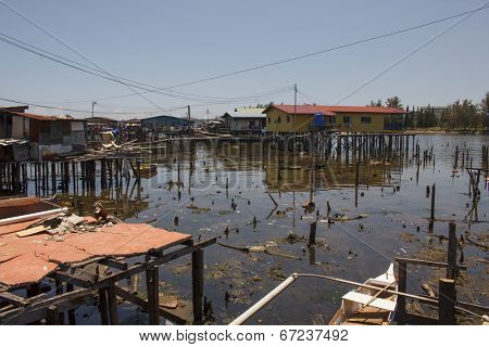 Wooden longhouses in poor Asian slum at risk from global warming and climate change 