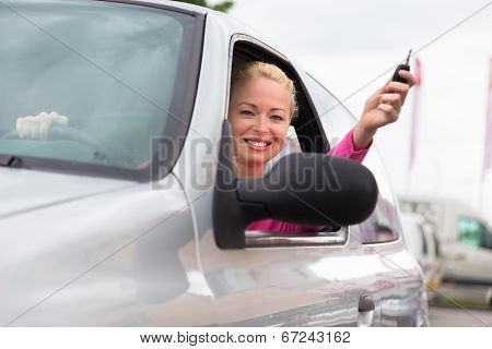 Woman driver showing car keys.