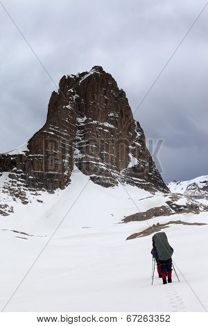 Two Hikers At Snowy Storm Mountains