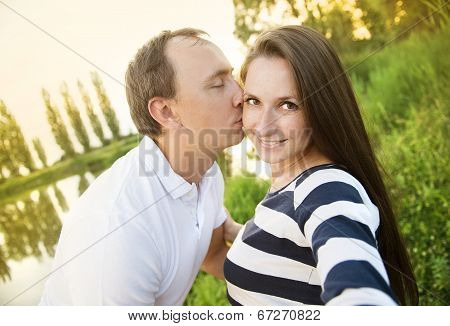 Pregnant couple taking selfie
