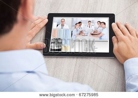 Businessman Video Conferencing With Medical Team