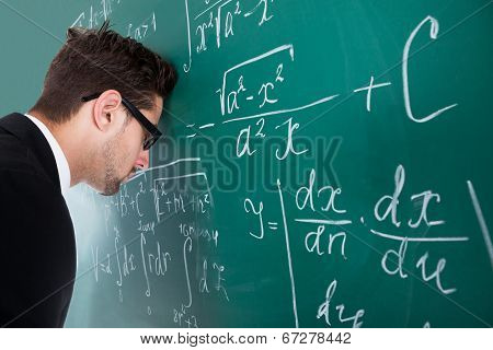 Professor Leaning Head On Blackboard