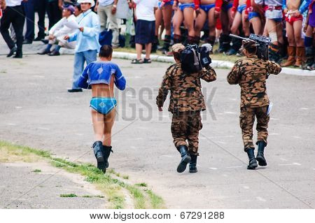 Mongolian Wrestler Walks With Soldiers At Nadaam Opening Ceremony