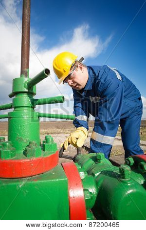 Worker on the oil field. Refinery, oil and gas