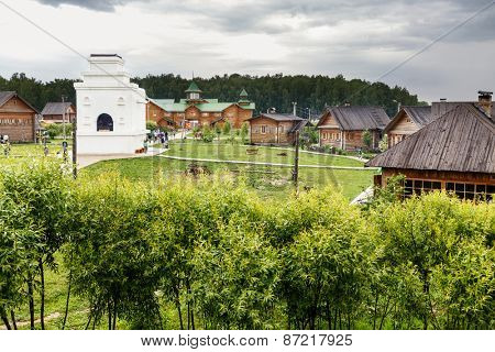 Traditional Russian wooden architecture and a monument to the Russian stove
