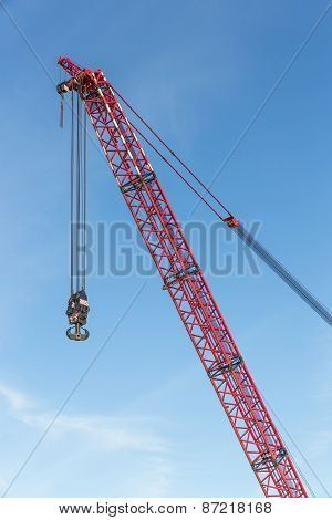 Red Crane Boom With Hook Against Blu Sky