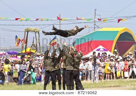 Dancing group in folk costumes and the form of the Soviet army at the festival Sabantui-2014