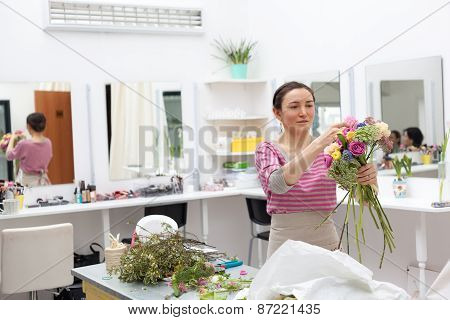 Masterclass Of Smiling Florist At Work With Bunch Of Flowers