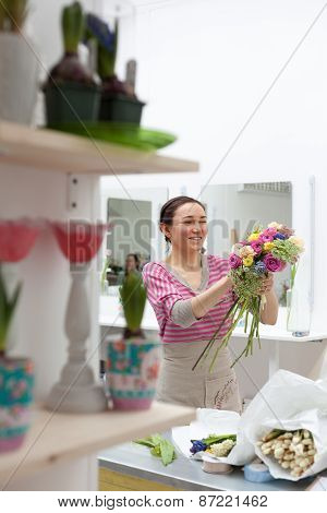 Masterclass Of Smiling Florist At Work With Bunch Of Flowers