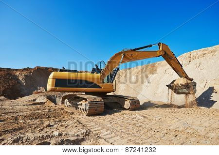 exavation machine excavator at earthmoving work in sand quarry