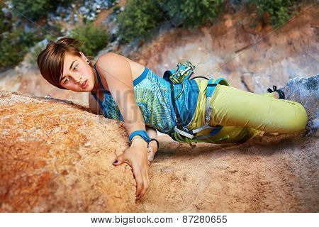 Rock climber climbing up a cliff