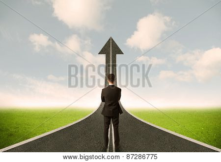 Businessman lokking at 3d road upgoing arrow concept