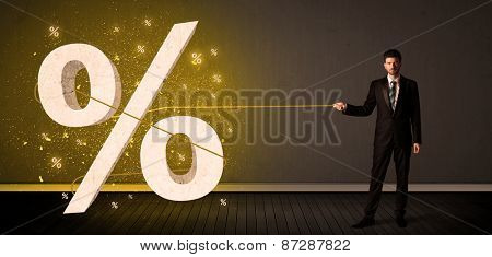 Business man pulling rope with big procent symbol sign concept on background