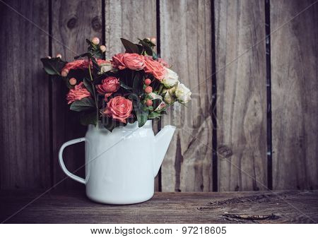 Bouquet of roses in vintage coffee pot