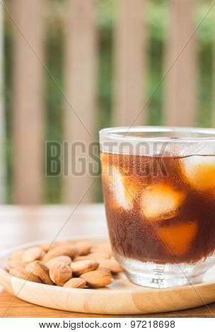 Glass Of Black Iced Coffee With Almond Grain