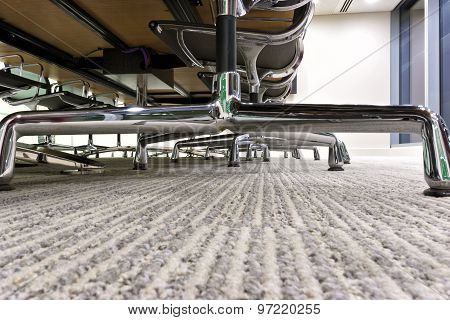 under office wooden desk chairs with metal silver legs in a modern boardroom