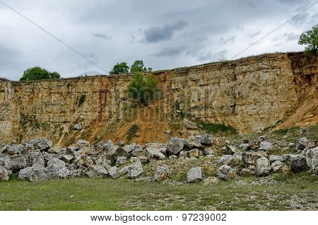 General view toward crag of sedimentary rock in the field