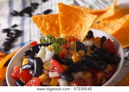 Mexican Salsa With Black Beans And Corn Chips Nachos Macro. Horizontal
