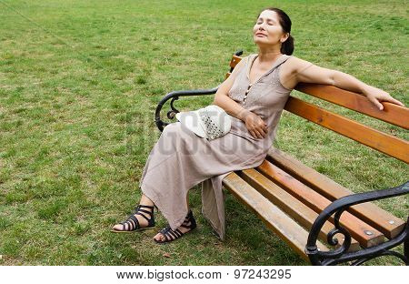 Woman sitting on park bench