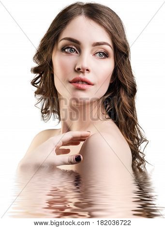 Young beautiful woman with reflection on water surface