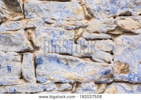Background wall made of stone. Fragment of a wall from a chipped stone
