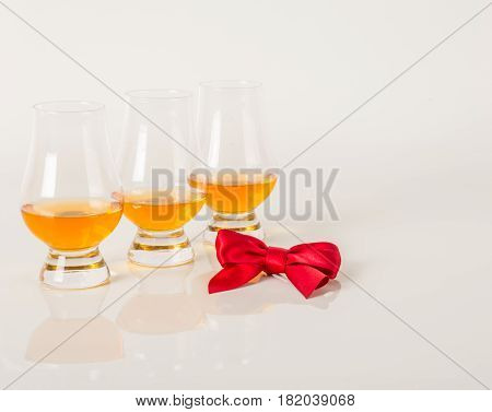 Set Of Single Malt Tasting Glasses, Single Malt Whisky In A Glasses, White Background, Red Bow