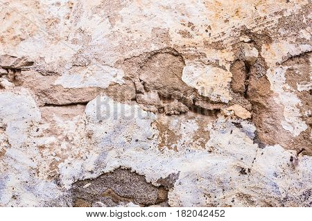 Background wall made of stone. Fragment of a wall from a chipped stone