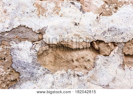Background wall made of stone. Fragment of a wall from a chipped stone
