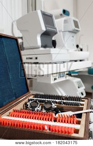 Optometry concept. test glasses phoropter with lens set for eye sight vision testing or examinations in clinic.