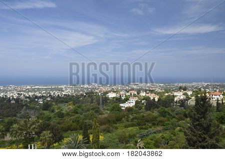 View to the North East over the Kyrenia town on the North of Cyprus with the Mediterranean sea and a blue sky in background .