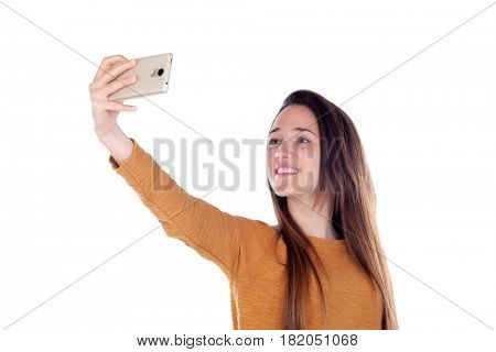 Teenager girl taking a selfie with her mobile isolated on a white background