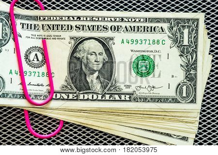 Dollar banknotes with pink clip stapled dollar money