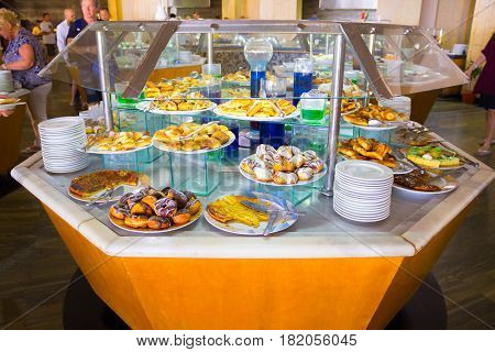 Sharm El Sheikh, Egypt - April 8, 2017: The people choose food in the buffet restaurant at luxury hotel Barcelo Tiran Sharm 5 stars at Sharm El Sheikh, Egypt on April 8, 2017