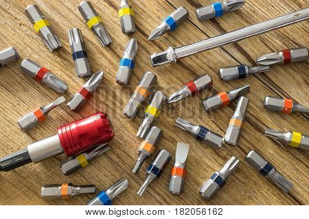 Screwdriver with color bits on the table