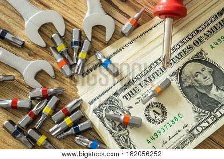Tool set and dollar money on wooden table