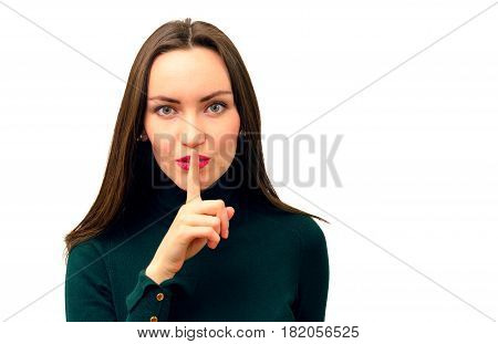 Modern and beautiful girl close-up puts one finger to his lips in sign of silence concept of silence