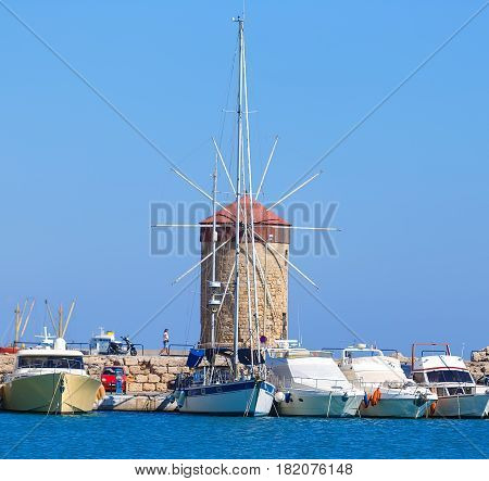beautiful medieval Windmill of Mandraki Harbor in Rhodes as majestic reminders of times