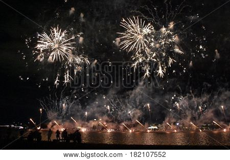 Skyfire 2017 in Canberra Australia. Fireworks during Canberra's annual SkyFire appear above Lake Burley Griffin. Australian Federation Guard at Gallipoli Reach behind the cannons.