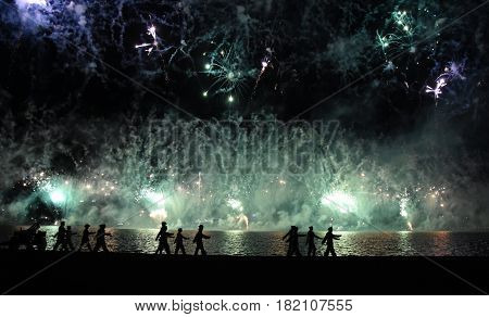 Skyfire 2017 in Canberra Australia. Fireworks during Canberra's annual SkyFire appear above Lake Burley Griffin. Australian Federation Guard moving away at Gallipoli Reach.