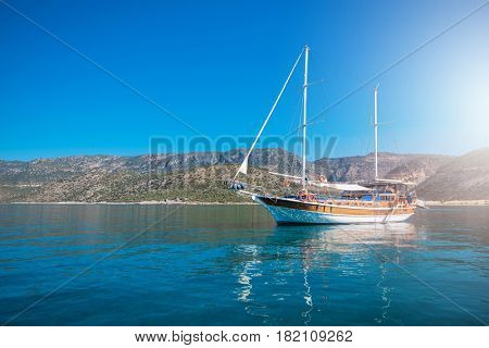 yacht on bay and castle in Kekova, near ruins of the ancient city on the Kekova island, Turkey