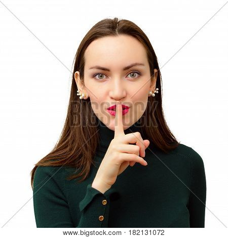 Modern and beautiful girl close-up puts one finger to his lips in sign of silence concept of silence