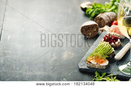 Tasty rye bread sandwiches withsalmon, avocado, beetroot, creamcheese, ham, herbs and spices