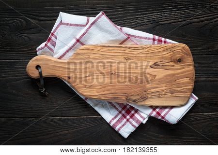 Food background. Olive Cutting board on dark wooden table. Copy space.