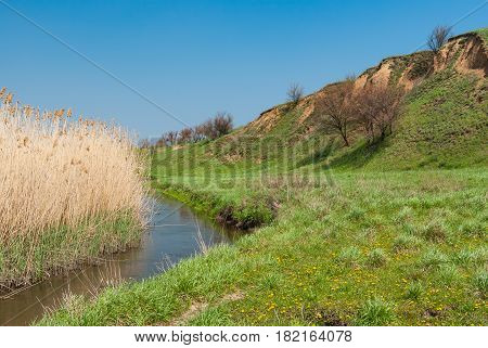 Spring landscape with small Ukrainian river Sura .