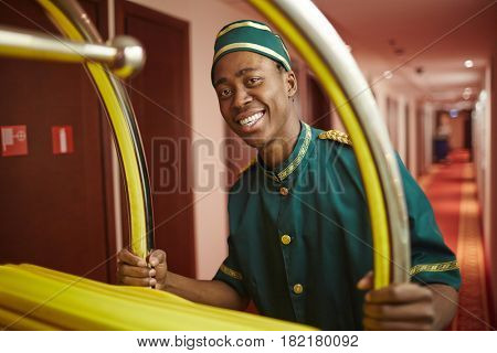 Happy porter doing his work in hotel