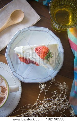 coffee cup and delicious cake strawberry and relax time moblie on table in coffee shop