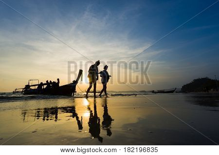 Ao Nang Krabi Thailand - March 02 2017: People on the Ao Nang beach at sunset in Krabi province Thailand