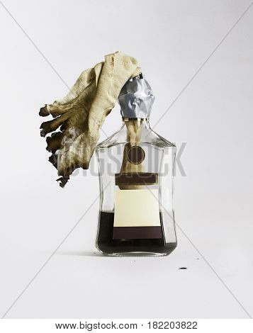 Incendiary mixture in a bottle of cognac on a white background.