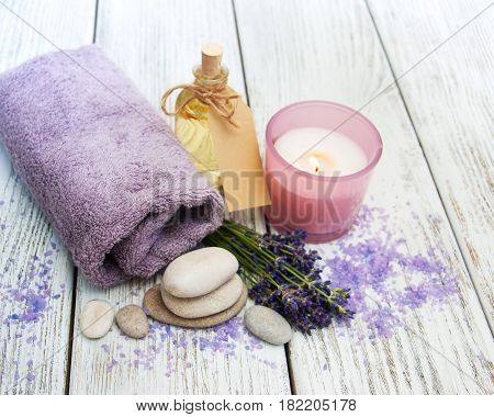 Lavender with essencial oil on a wooden table